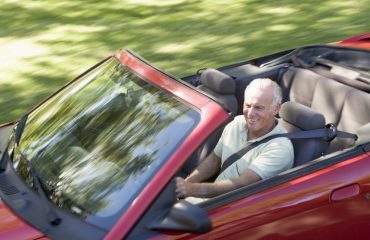 Man in convertible car smiling Man in convertible car smiling