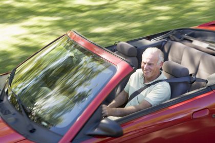 Man in convertible car smiling