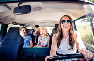 Teenage boys and girls inside an old campervan, roadtrip car window tinting